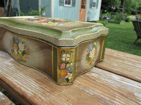 Vintage embossed metal box / blue flower hinged lid / Marked 